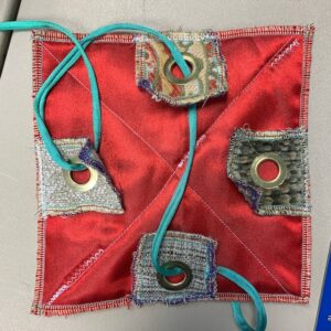 Tags with grommets and string looped through